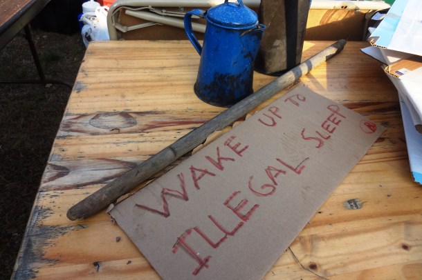 "Wake Up to Illegal Sleeping," says the sign that desicribes the experience of Occupy Madison this morning. Photo by Rebecca Kemble