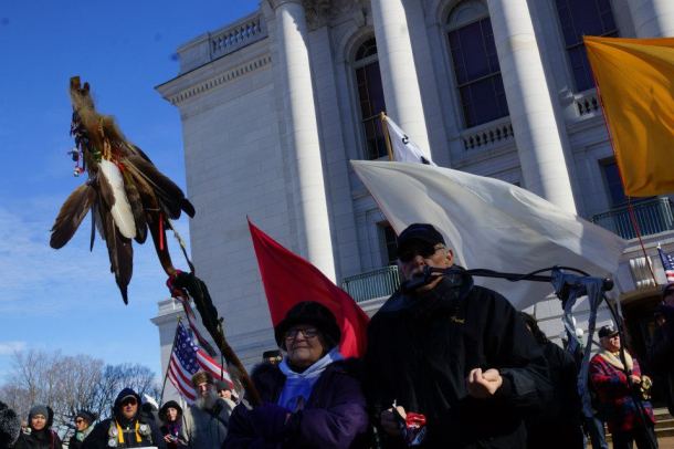  Fran Van Zile and Fred Ackley from the Mole Lake Sokoagon Ojibwe community, also veterans of the fight against the Crandon mine, make a tobacco offering in front of the crowd 1/26/13