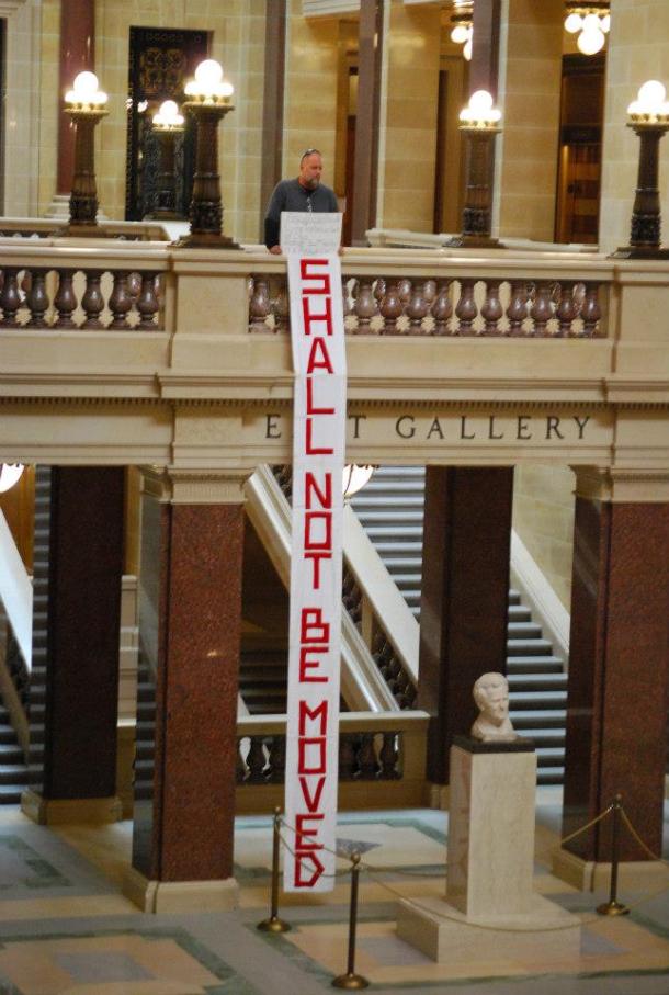 Bart Munger holds the banner seized by Capitol Police as a safety hazard. Photo courtesy Lisa Wells.