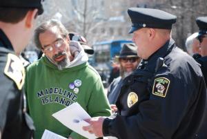 Capitol Police Officer Brian Henry attempts to deliver citations. Photo by Lisa Wells.