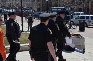 Capitol Police march down the stairs to deliver citations. Photo by Dawn Henke.