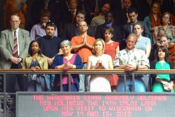 Visitors in the public gallery stand for His Holiness the 14th Dalai Lama. Photo by Rebecca Kemble