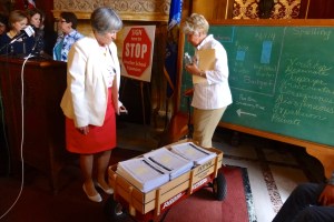 Rep. Janet Ringhand (D-Janesville) and Rep. Sondy Pope (D-Middleton) with a wagon full of 16,809 signatures.