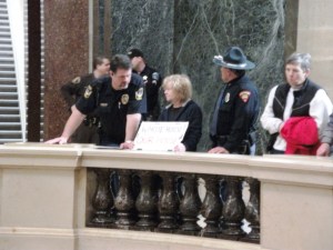 Capitol Police and Wisconsin State Patrol officers harass a peaceful citizen holding a sign.