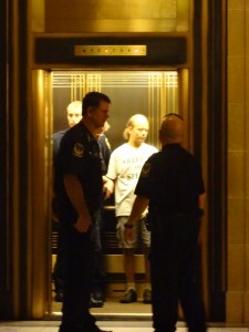 Capitol police officers arresting a man for holding a sign in September, 2012.