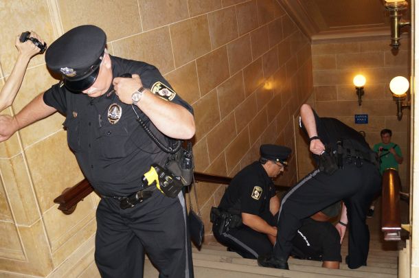 Will Williams arrested in WI Capitol 8.1.13 falls while handcuffed and under arrest in WI Capitol 8.1.13. Photo by Leslie Amsterdam