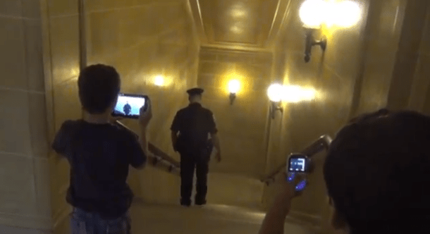 Two young boys tape arrests in Wisconsin Capitol.