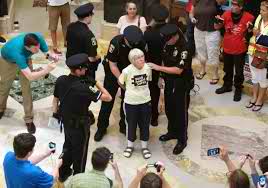 80-year-old Joan Kemble arrested for singing.
