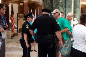 Veteran for Peace Norman R. Aulabaugh was part of a group of veterans being told they would be arrested if they observed the Solidarity Sing Along at the State Capitol. Photo: Rebecca Kemble
