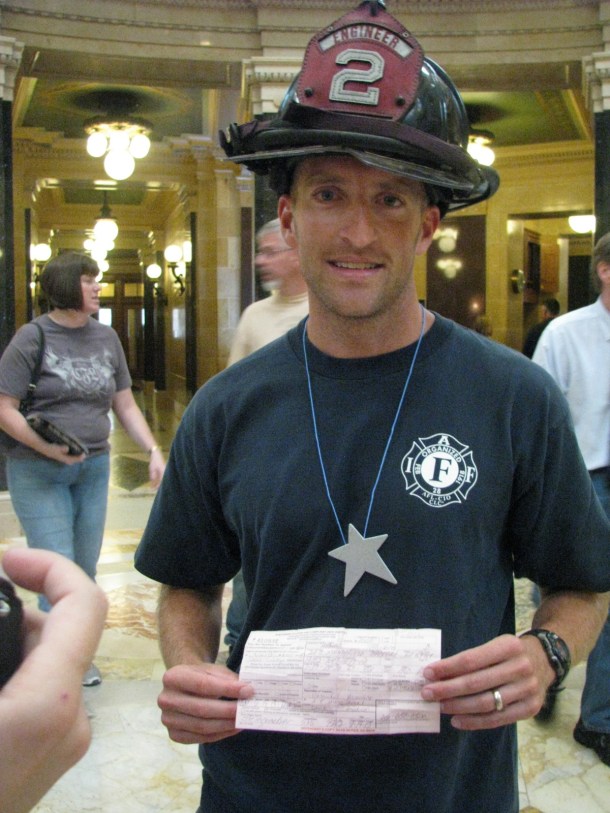 Madison firefighter Ted Higgins shows off his citation.