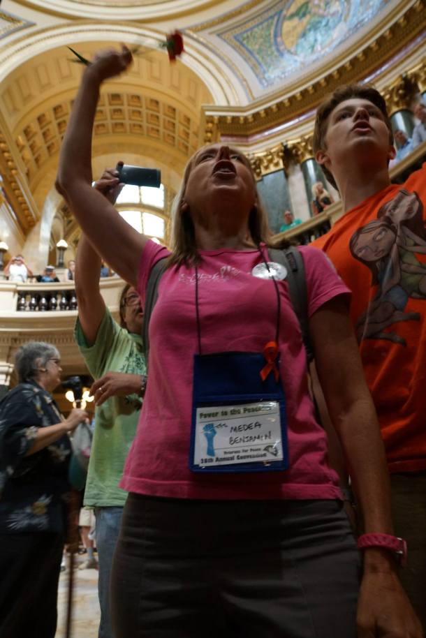 August 8, 2013 Medea Benjamin  and Jack sing immediately before jack, a minor, is arrested for singing in the WI Capitol rotunda without a permit.