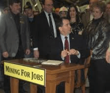 Leslie Kolesar is seen behind Walker at the Act 1 bill signing.