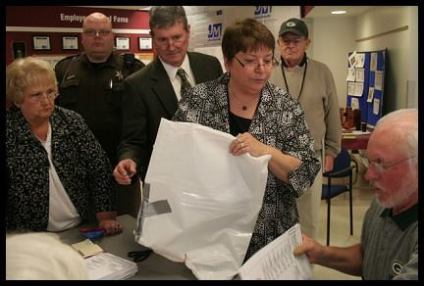 Duct taped ballot bags from the Village of Menomonee Falls are presented to the election judge.