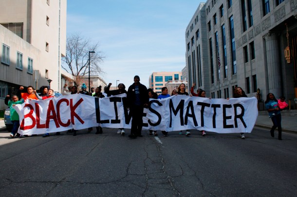 Eric Upchurch II of Young, Gifted & Black Coalition leads the march to the offices of Dane County DA Ismael Ozanne.