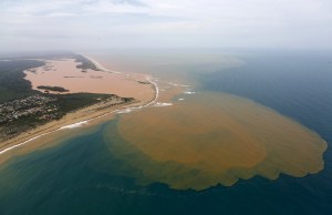 An aerial view of the Rio Doce (Doce River), which was flooded with mud after a dam owned by Vale SA and BHP Billiton Ltd burst, at an area where the river joins the sea on the coast of Espirito Santo in Regencia Village, Brazil, November 23, 2015. REUTERS/Ricardo Moraes